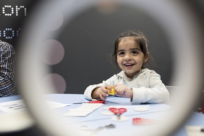 a little girl doing crafts at the Transport Museum