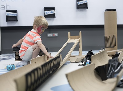 little boy testing a mdel car