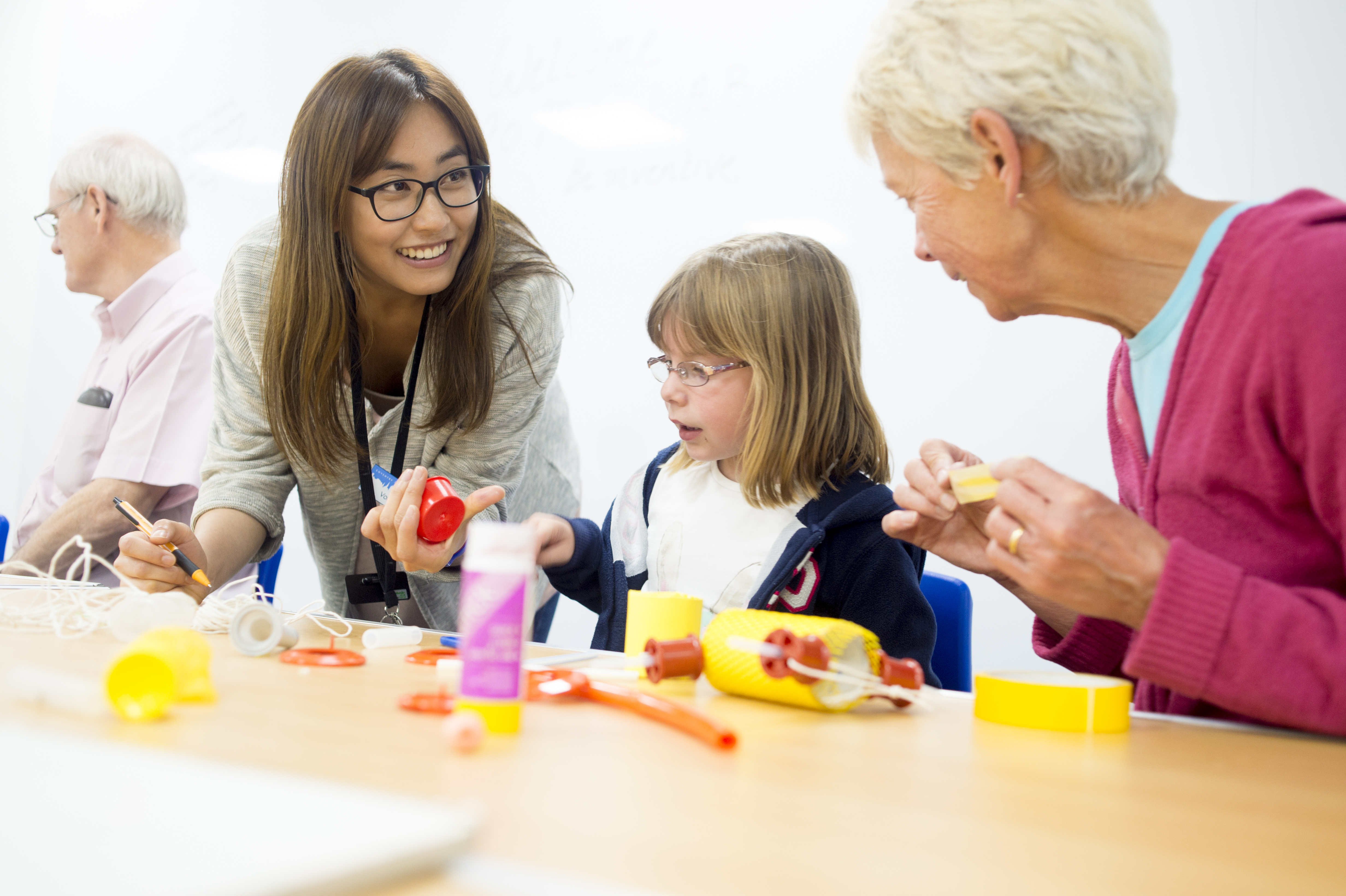 Adults and child making creative items