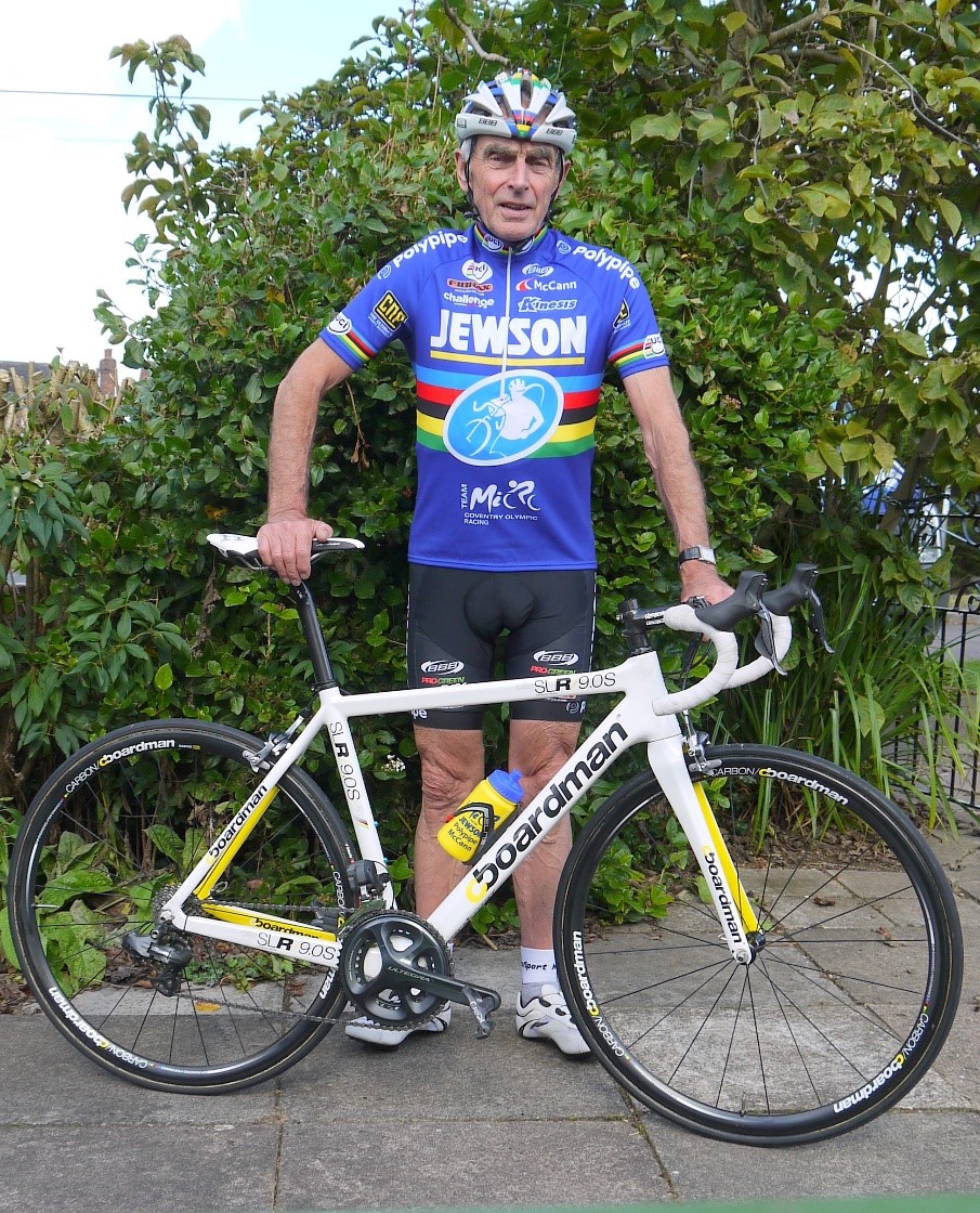 Mick Ives standing next to a bike