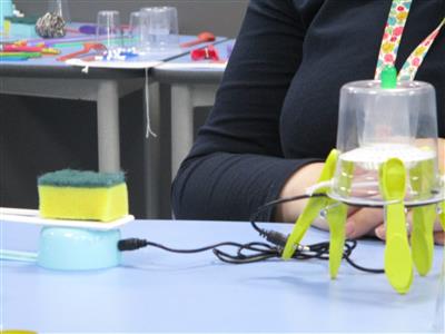 an invention made of sponge, pegs, cups and cables