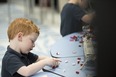 Young boy playing with Lego